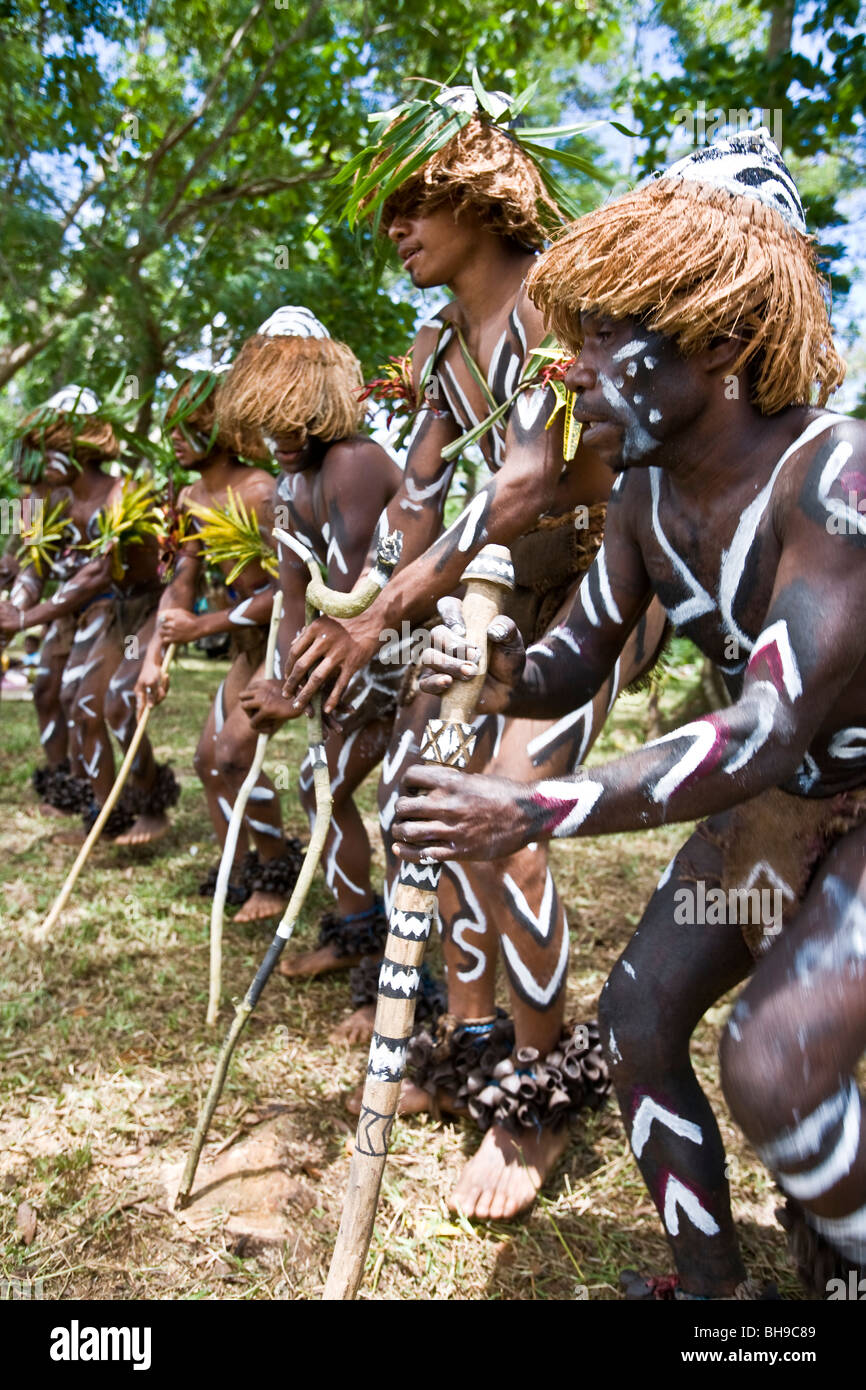 In Melanesia e Isola Salomone itinerario guerrieri locale eseguire vigorosa danze di guerra come parte della cerimonia di benvenuto Foto Stock