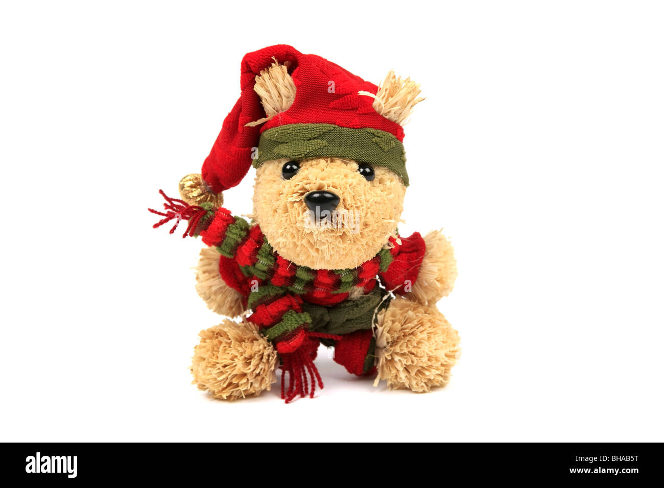 Orsacchiotto di peluche che indossa un cappello rosso e sciarpa contro uno sfondo bianco Foto Stock