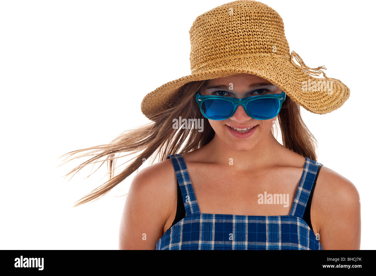 Pretty girl teen in blu di occhiali da sole e un cappello di paglia Foto Stock