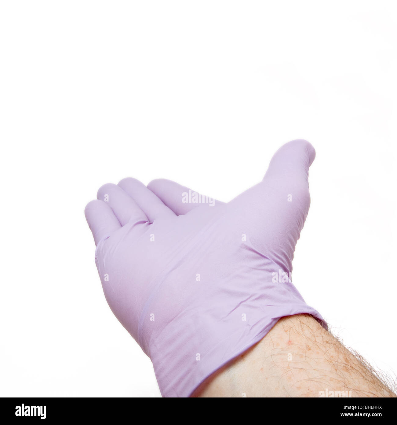 Maschio lato indossando viola lattice guanto chirurgico gesti isolati contro uno sfondo bianco. Foto Stock