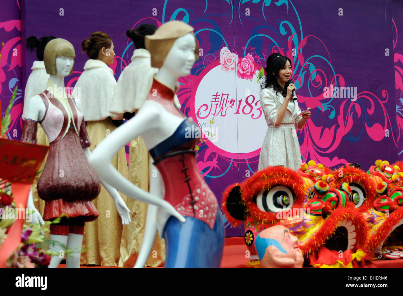 Bella donna cinese annunciatore all apertura di un Guangzhou negozio di moda. Foto Stock