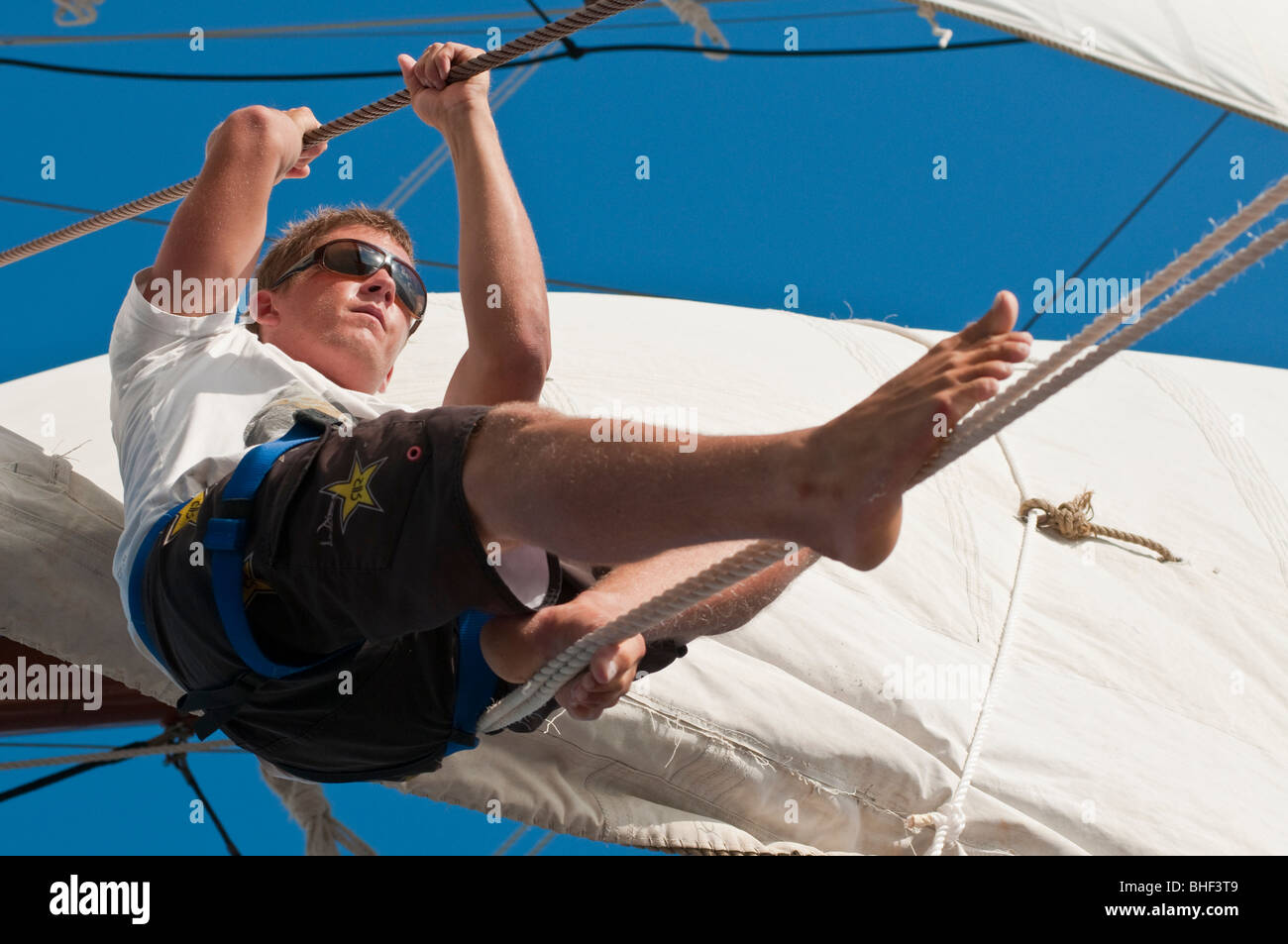 Membri dell'equipaggio della nave a vela Solway Lass, dotata di mezzi quadrati, che lavorano in alto sotto la vela Foto Stock
