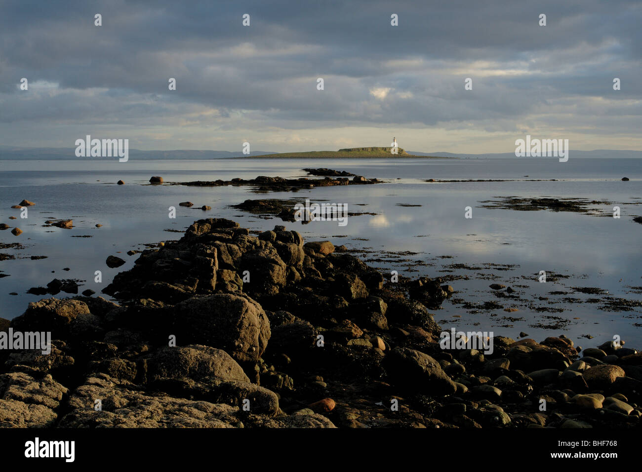 Pladda faro al tramonto da Kildonan Shore sull'isola di Arran Ayrshire in Scozia Foto Stock