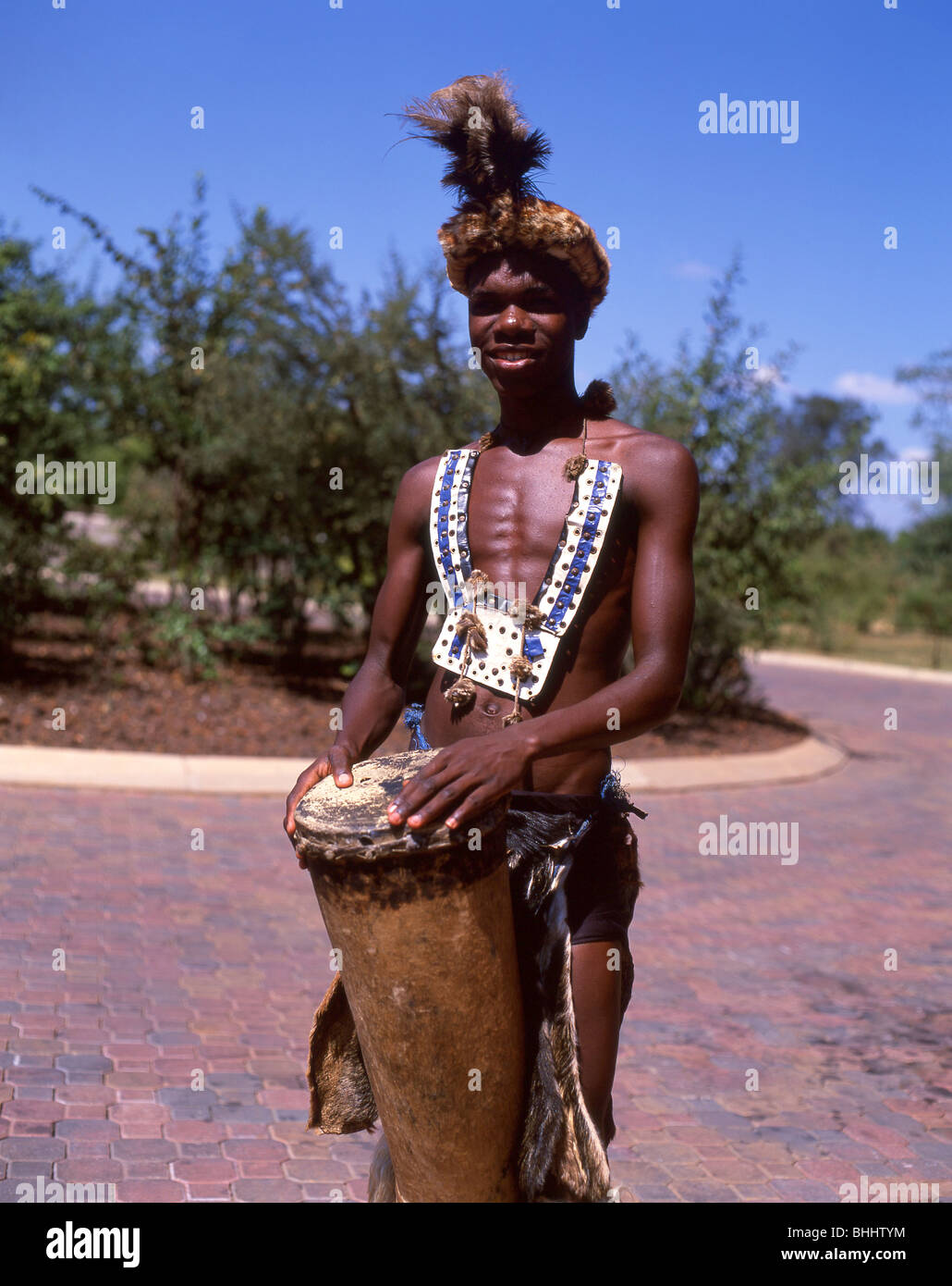 Uomo in abito nativo suonando la batteria, Victoria Falls Livingstone, sud della provincia, Repubblica di Zambia Foto Stock