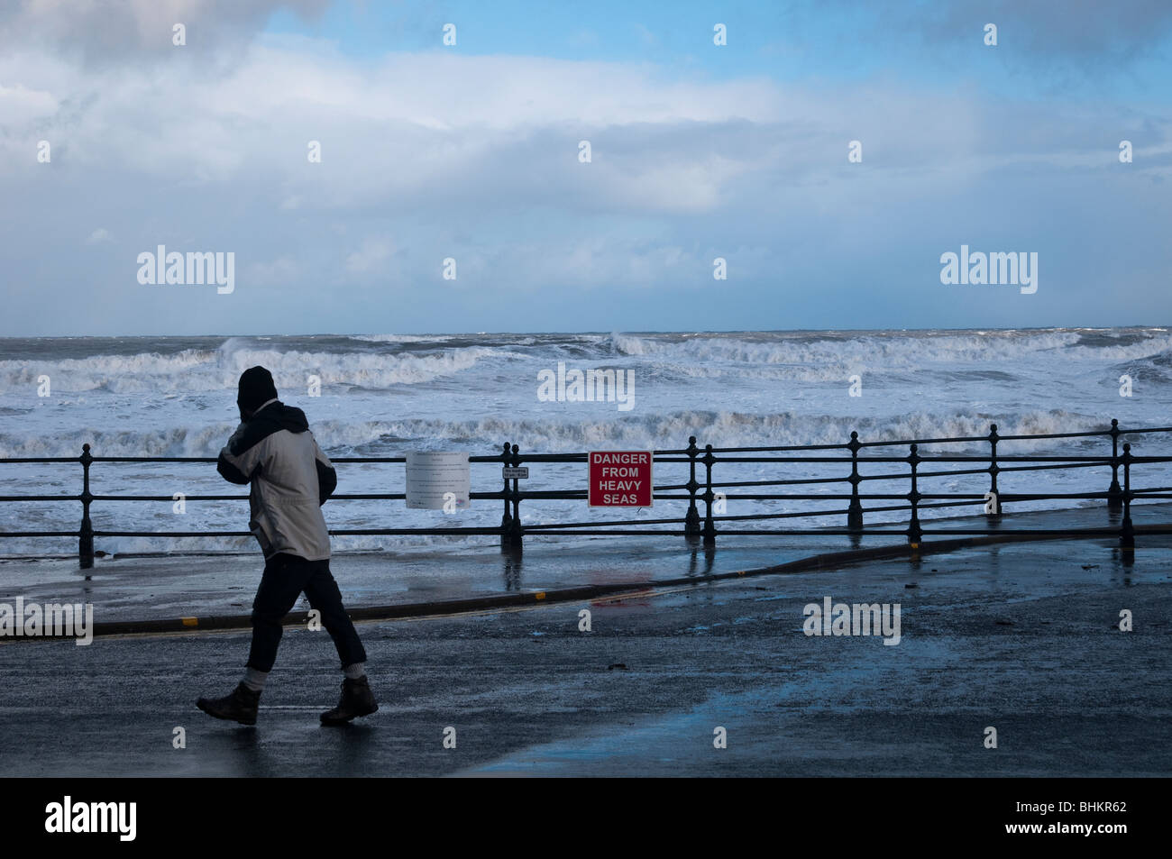 Persona da passeggiate le onde del mare in tempesta di neve, Scarborough Foto Stock