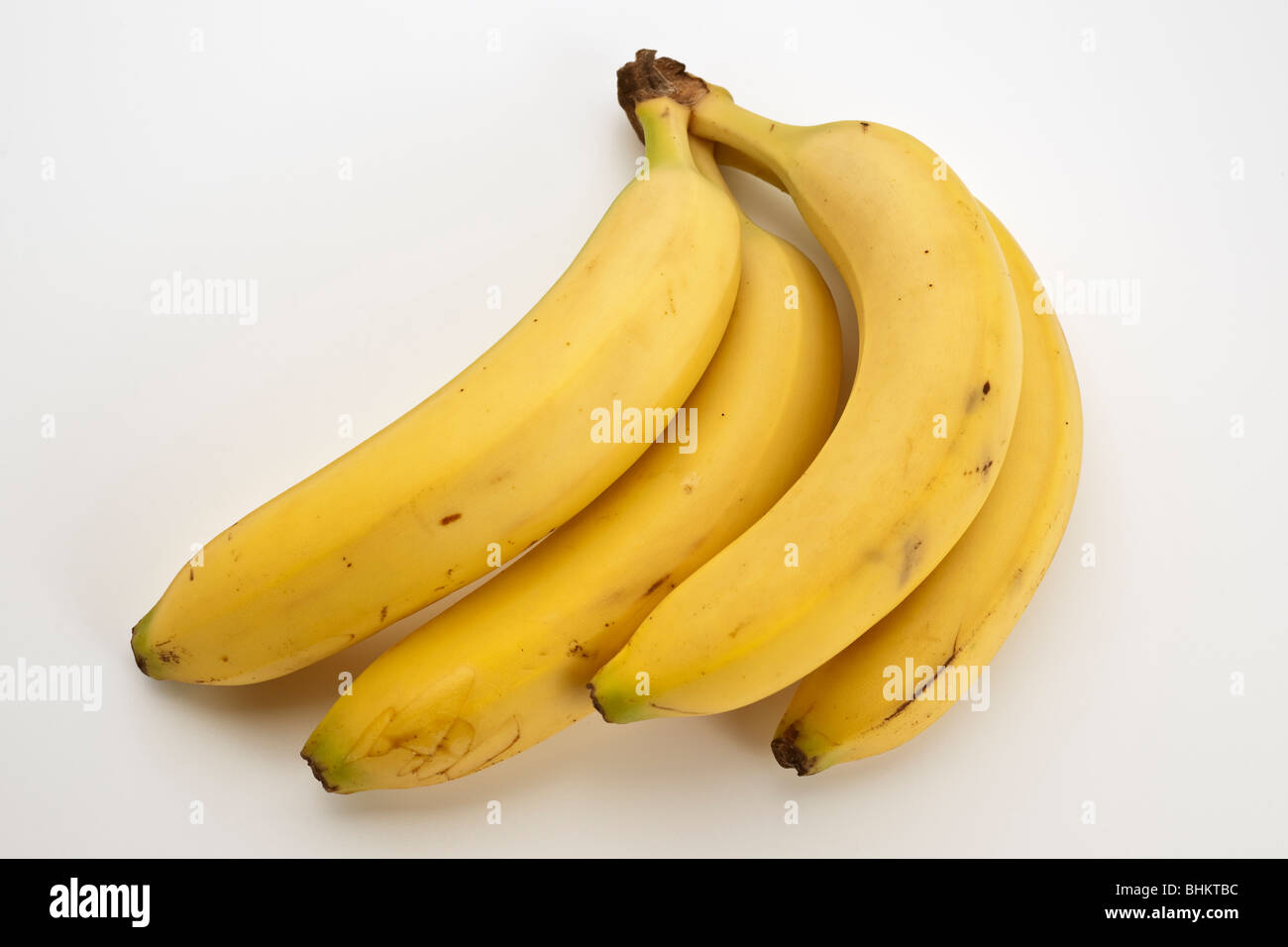 Quattro unita giallo banane mature Foto Stock