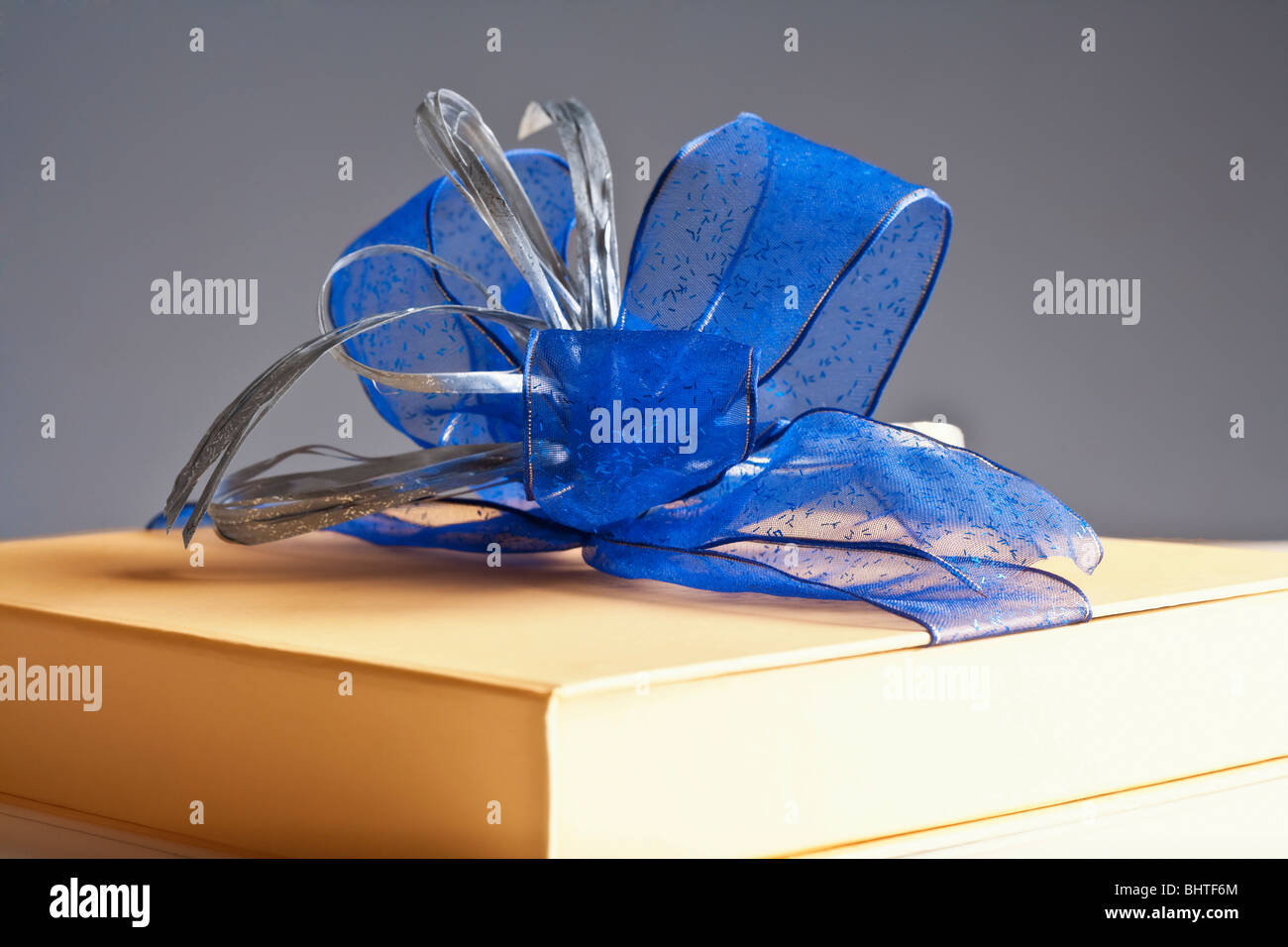 Presente - luxury gift box decorato con nastro blu su sfondo grigio Foto Stock