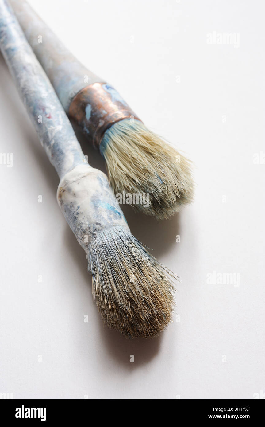 vecchi pennelli di vernice su sfondo bianco Foto Stock