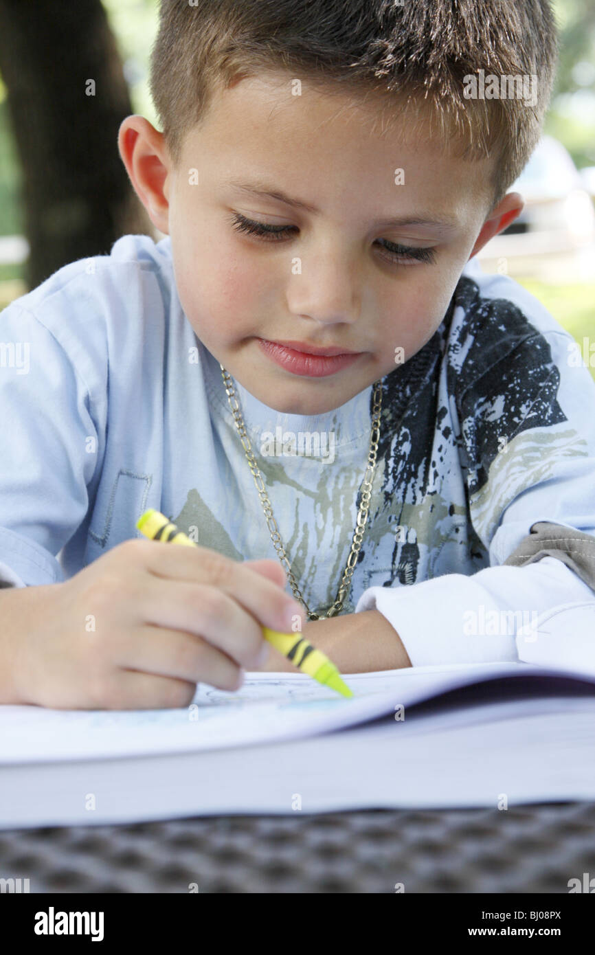 Bambino disegno in un libro da colorare Foto Stock