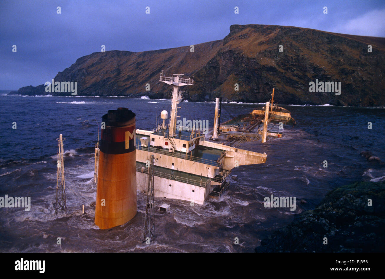 Onde tempestose crash oltre la sua super-struttura e imbuto della Liberia registrato-MV Braer petroliera naufragata sulle rocce. Foto Stock