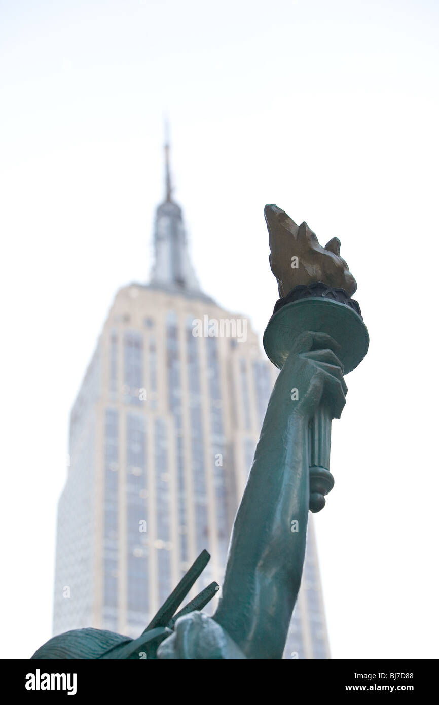 Una statua della Libertà replica braccio vicino all'Empire State Building. Foto Stock