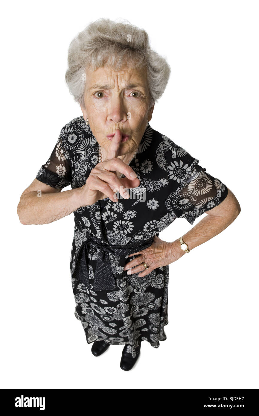 Senior donna shushing fotocamera. Foto Stock