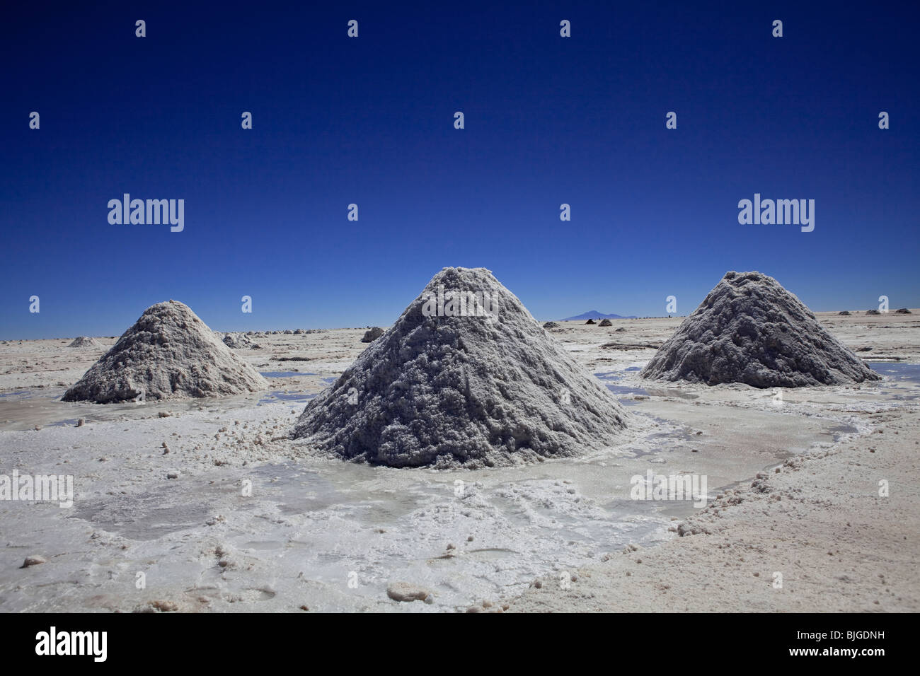 Le saline con sale impilati pronti per essere raccolti dal carrello. Uyuni, Altiplano, Potosi, Latina Salar Bolivia America del Sud. Foto Stock