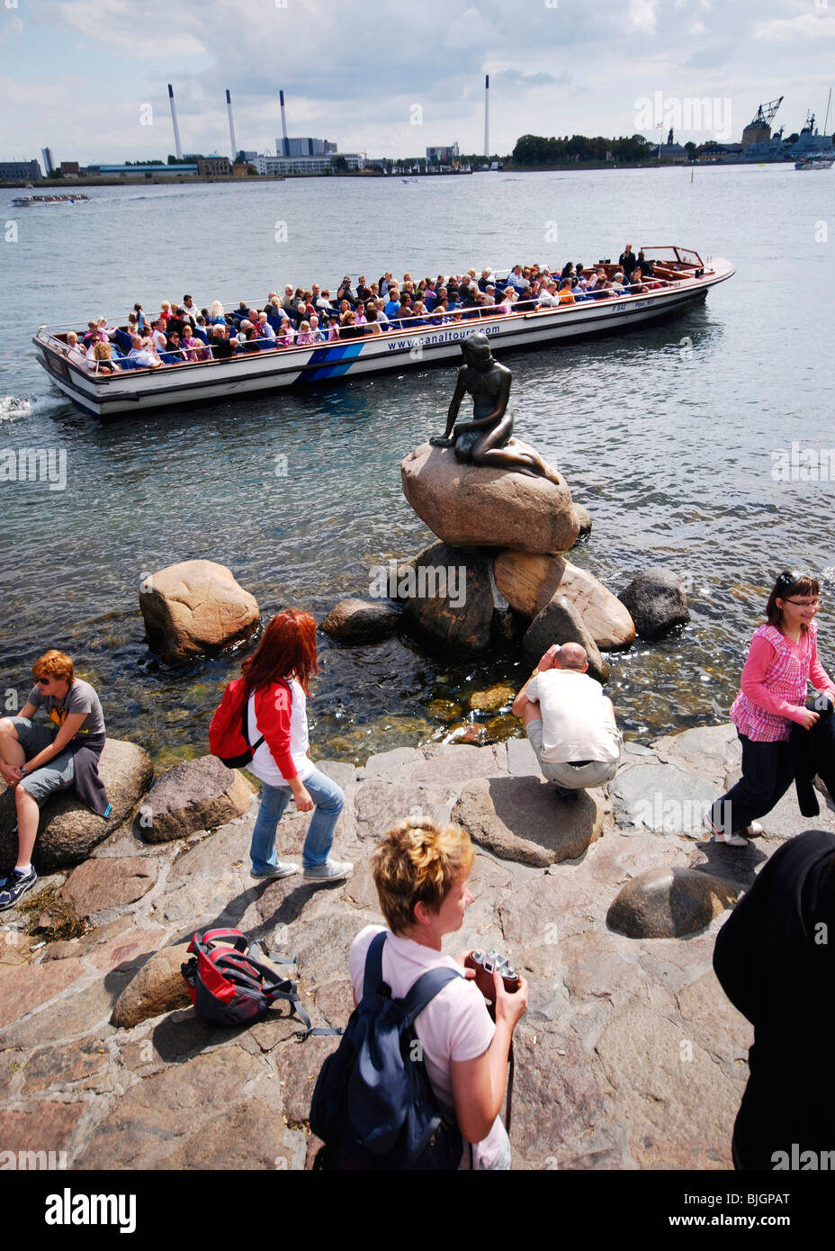 I turisti si riuniscono intorno a Copenaghen di attrazione turistica principale: la scultura in bronzo Den lille havfrue, La Sirenetta. Foto Stock
