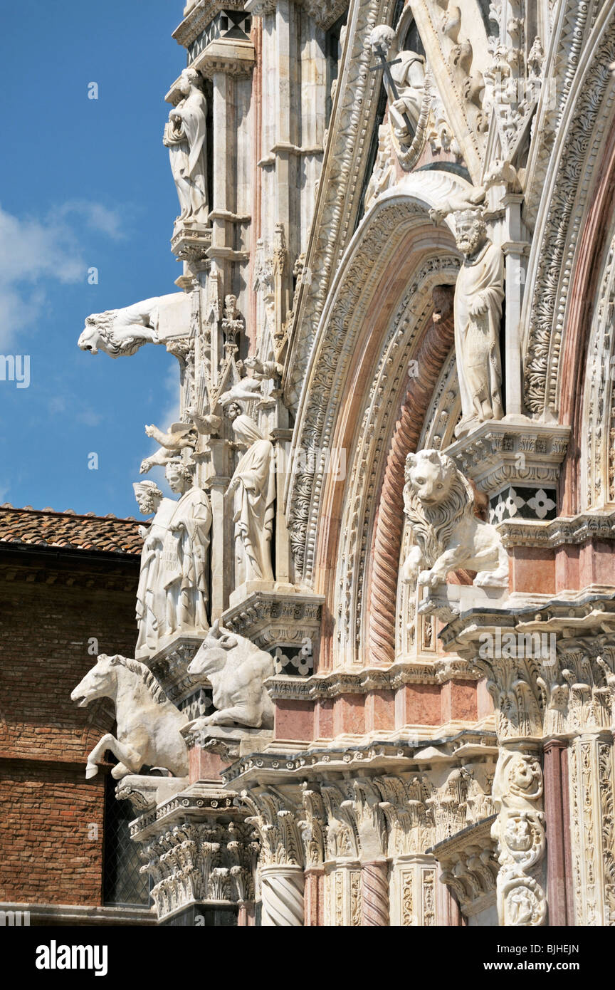Cattedrale di Siena, Toscana, Italia. La caramella-striped facciata principale del duomo adornata con bestie e intricati intarsi Foto Stock