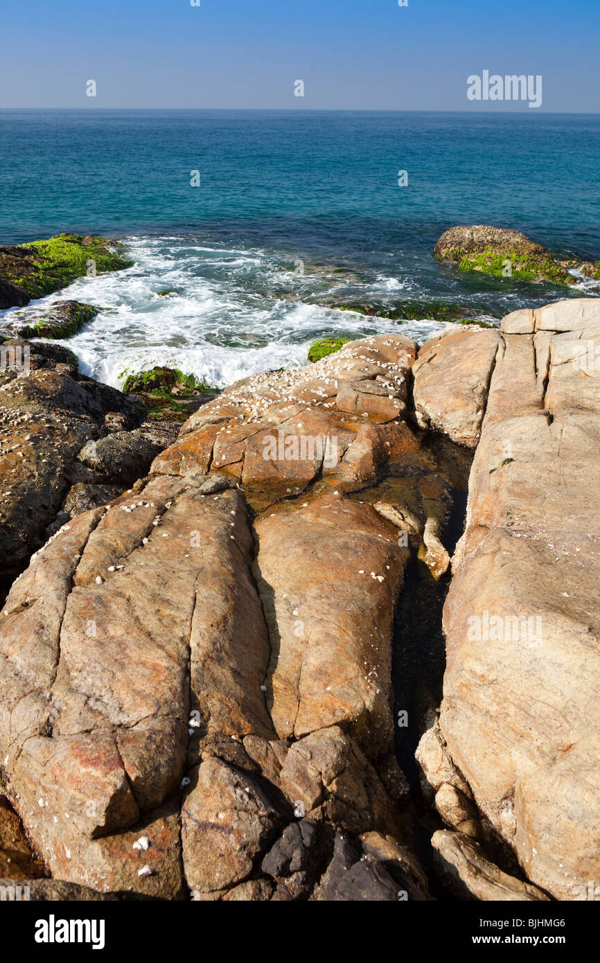 India Kerala, Kovalam, onde il rotolamento sul promontorio roccioso tra Vizhinjam e dalla spiaggia del Faro Foto Stock