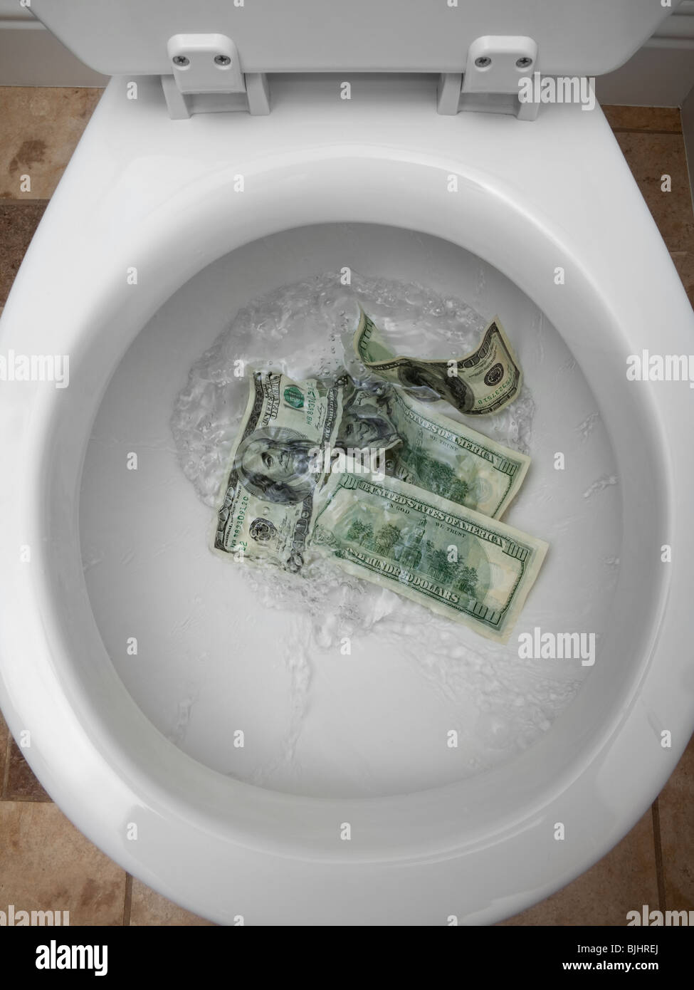 Soldi giù il wc Foto Stock