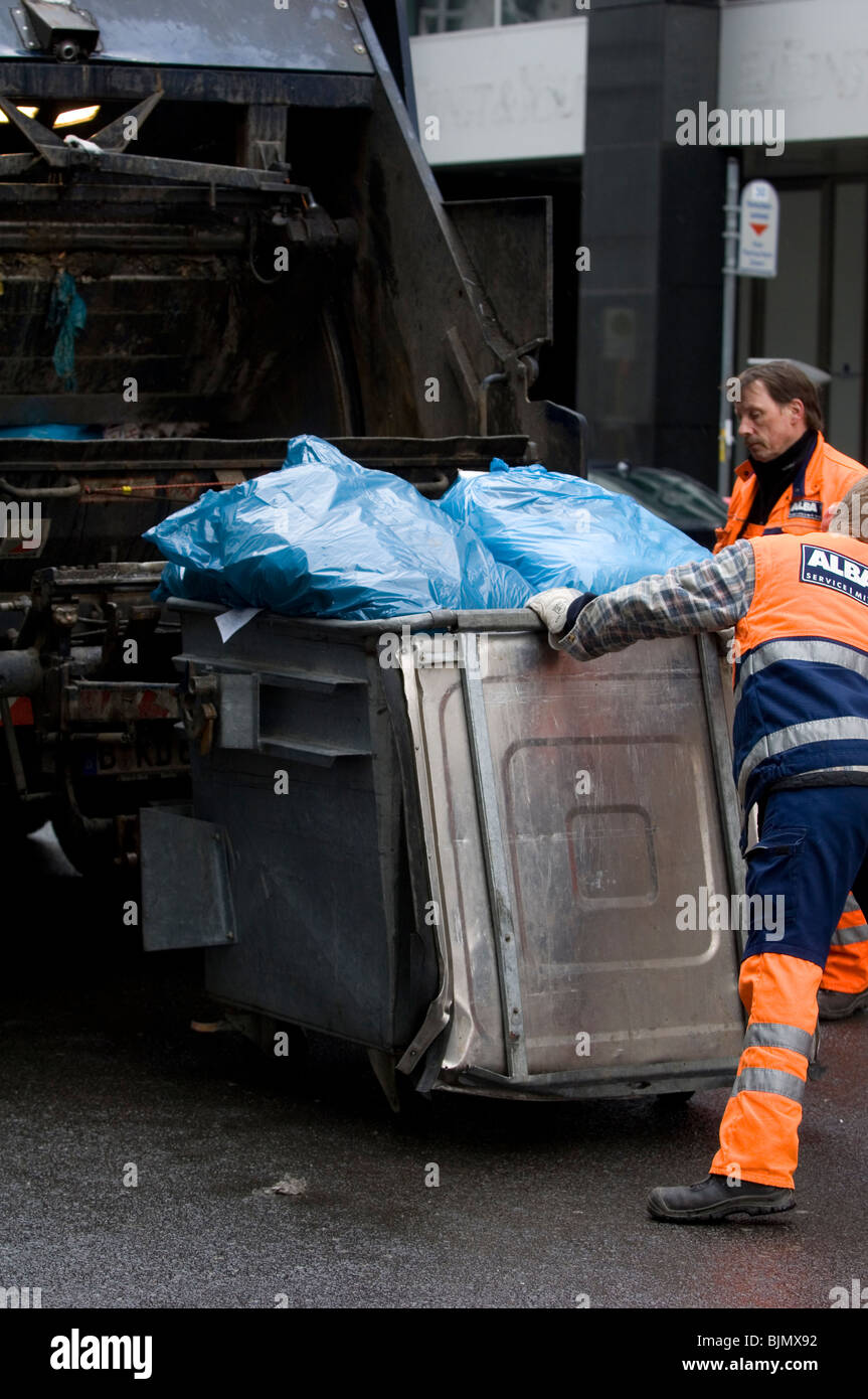 Gli uomini di immondizia nel cestino di caricamento nel carrello città di Berlino Germania Europa Foto Stock