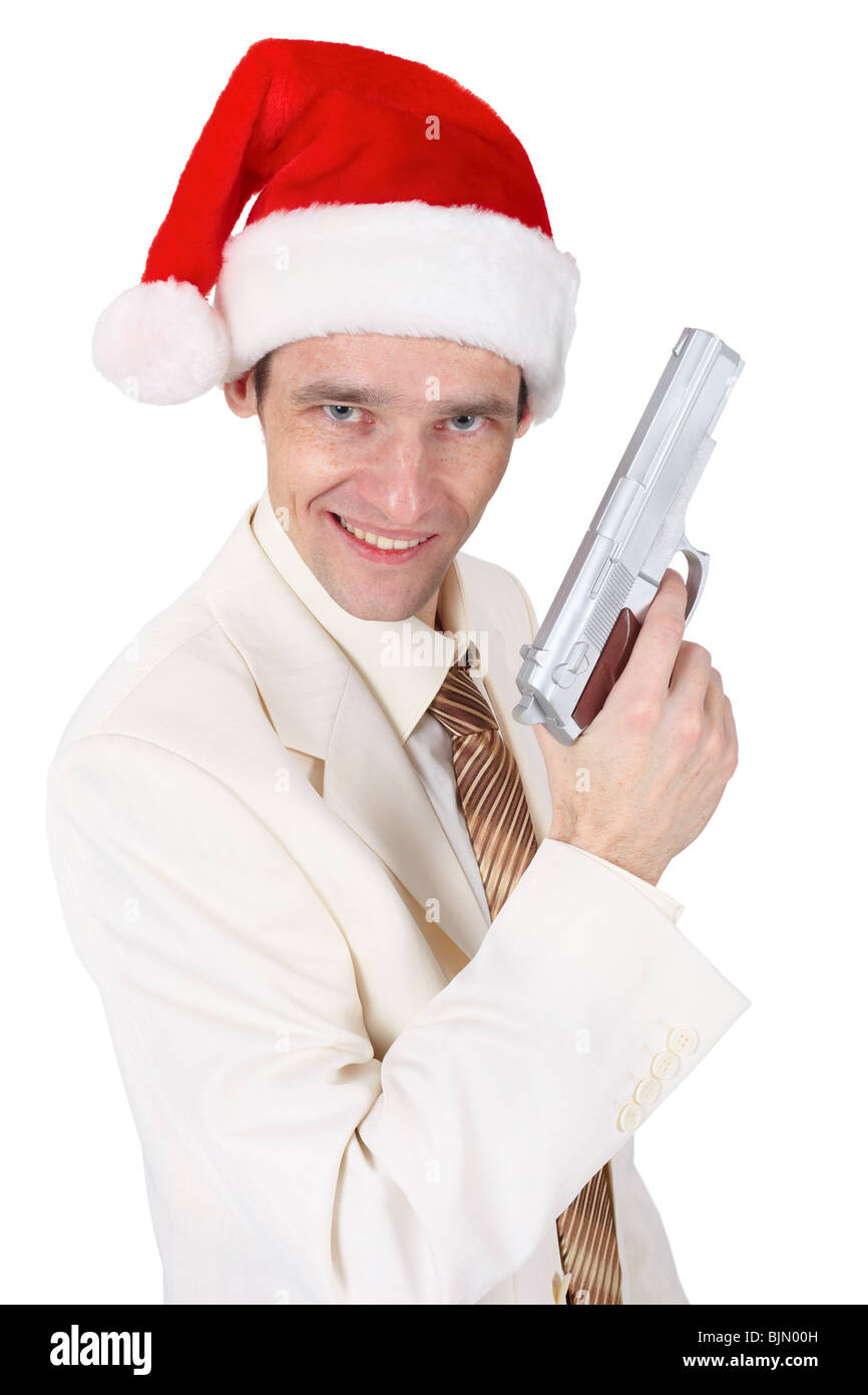 Buon ragazzo nel cappello di Natale con una pistola su bianco Foto Stock