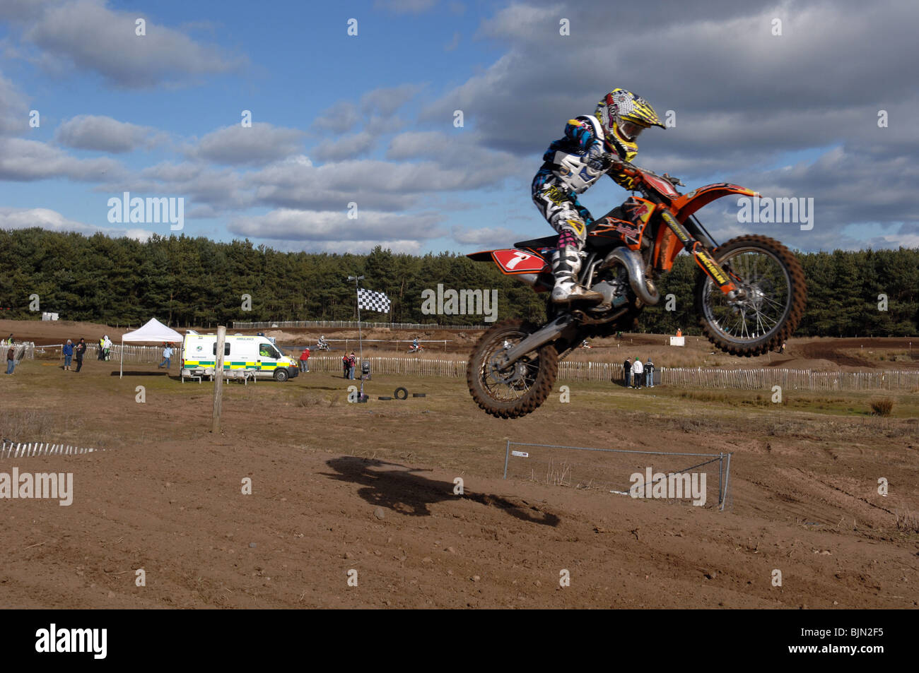 Motociclista volare in aria in alto sulla sua moto motocross Foto Stock