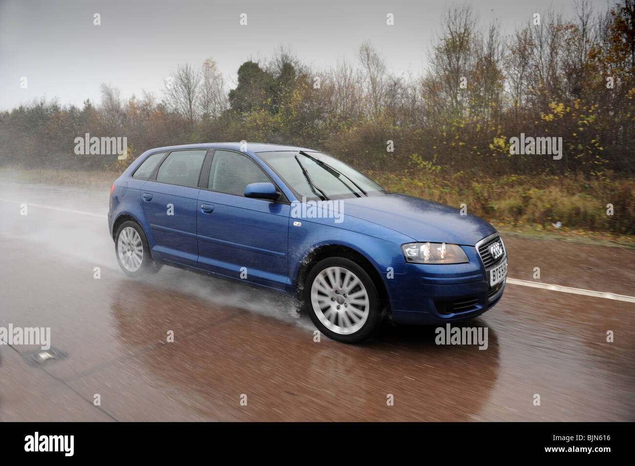 Audi A3 auto in heavy rain per autostrada uk Foto Stock
