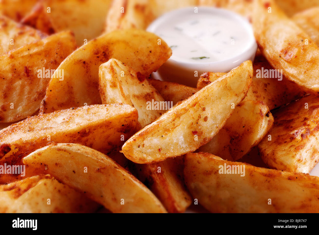 Spicchi di patate con un tuffo cibo foto Foto Stock