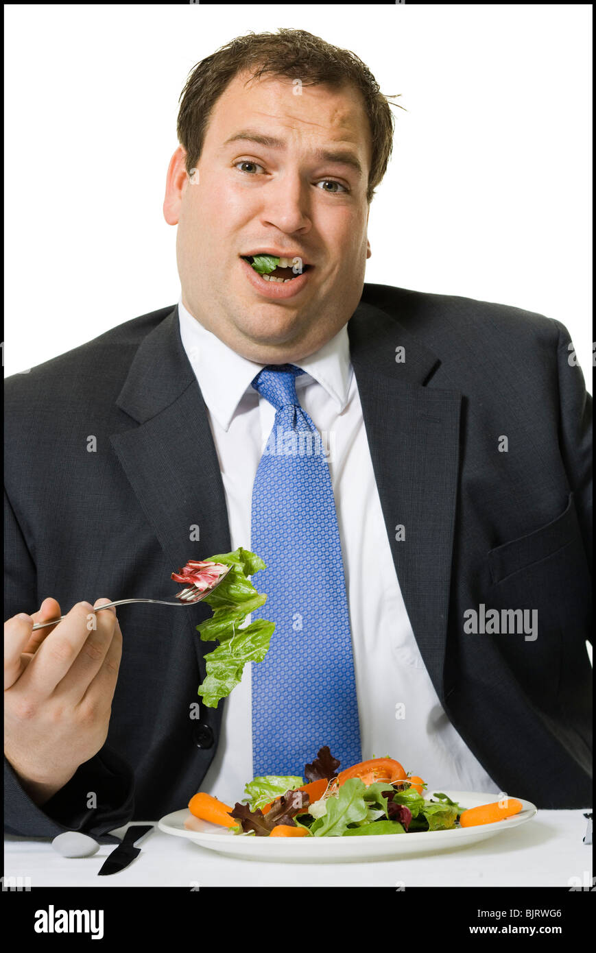 Imprenditore in sovrappeso di mangiare un pranzo insalata Foto Stock