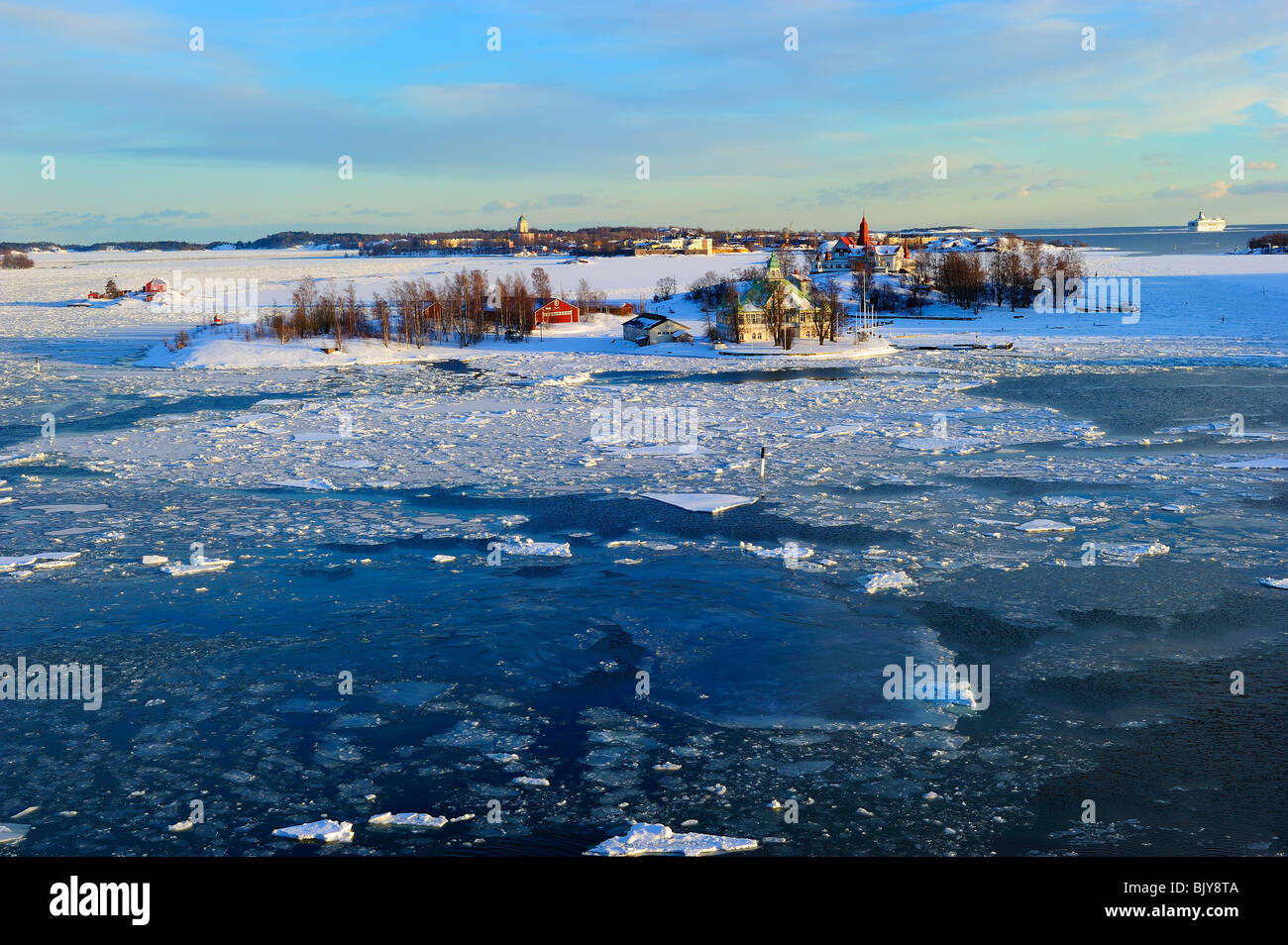 Icy Mar Baltico a Katajanokka Helsinki, con case finlandese su Valkosaari e isole Luoto Foto Stock