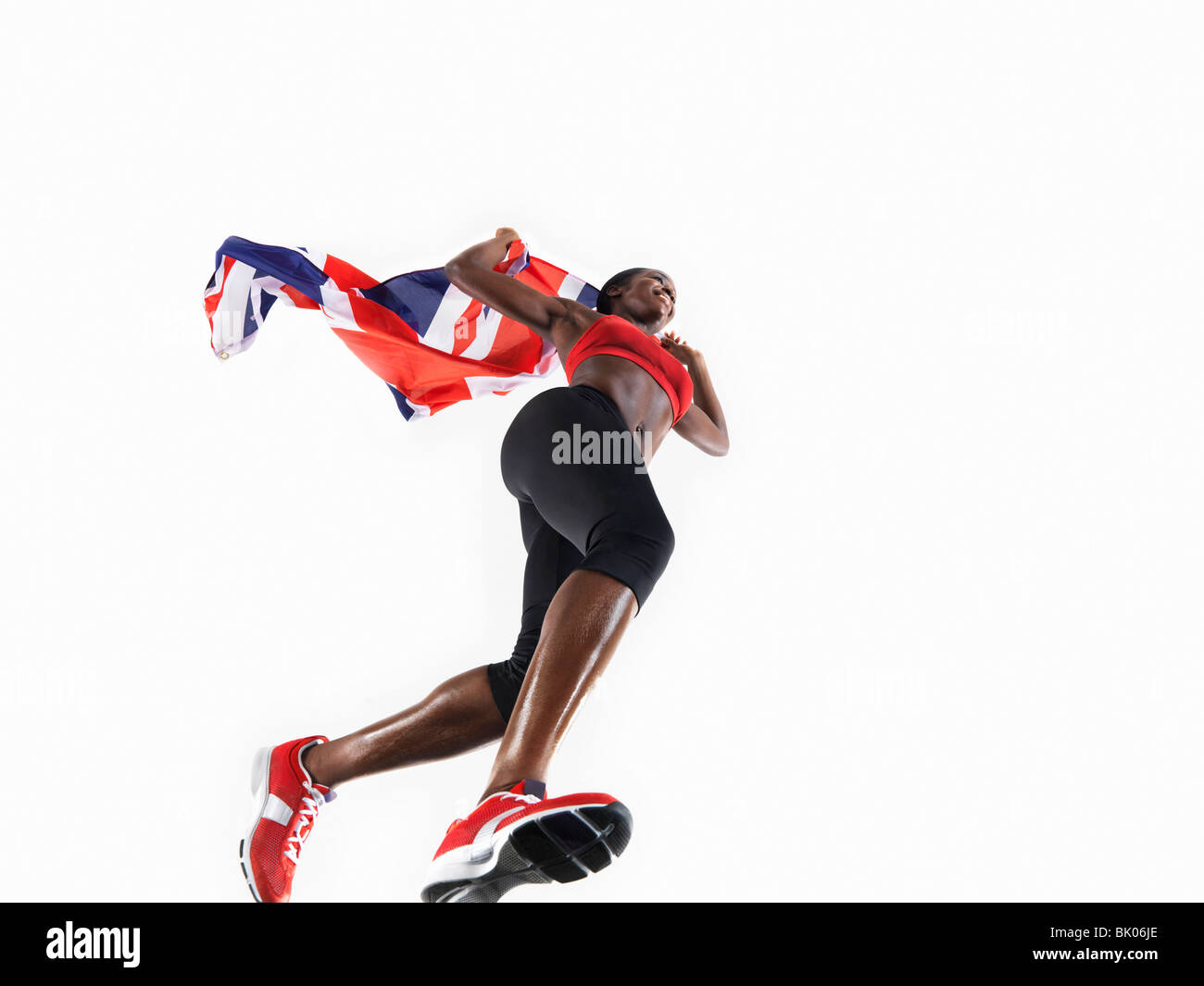 Atleta femminile in esecuzione con unione jack Foto Stock