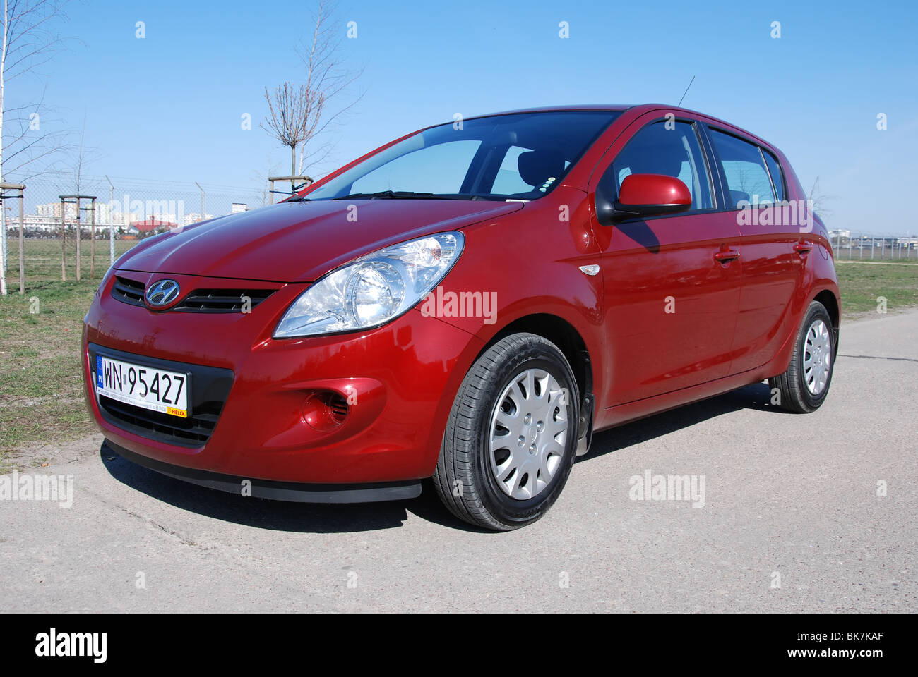 Hyundai i20 1.2 - Il mio 2008 - Rosso metalizzato - cinque porte (5D) - Coreano ultracompatto che sta popolare city car - su uno spazio di parcheggio Foto Stock