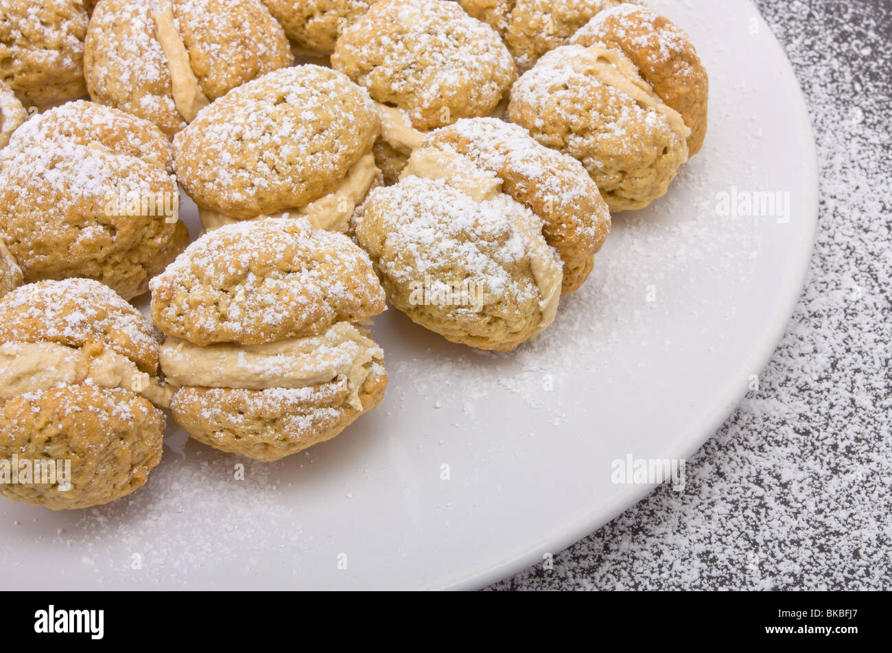 Caffè Kiss biscotti con spolverata di zucchero a velo e il burro ripieno di panna. Foto Stock