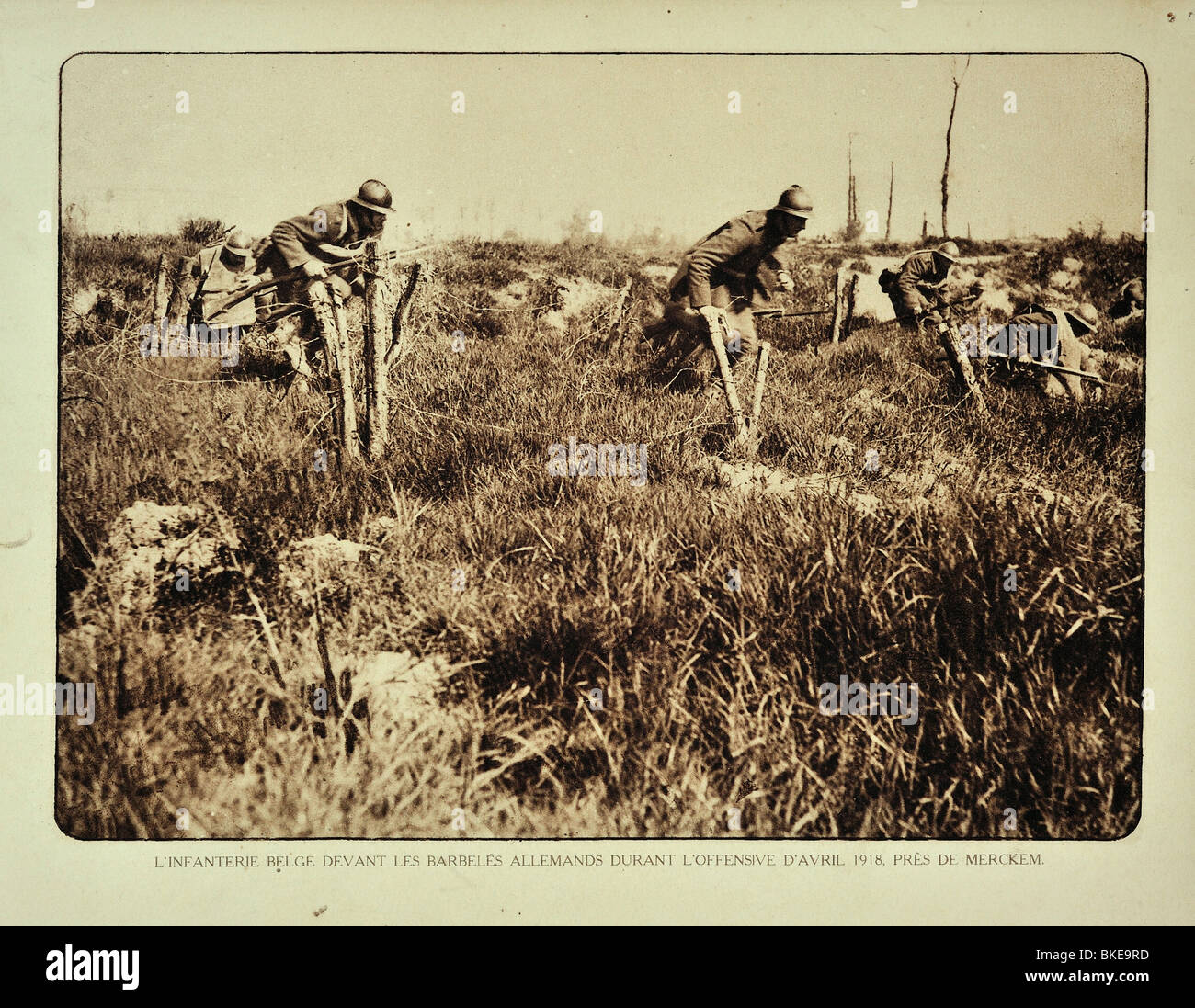 I soldati di fanteria tedeschi di carica e attraversando barbwire ostacoli nel campo di battaglia della Fiandra occidentale durante la Prima Guerra Mondiale, Belgio Foto Stock