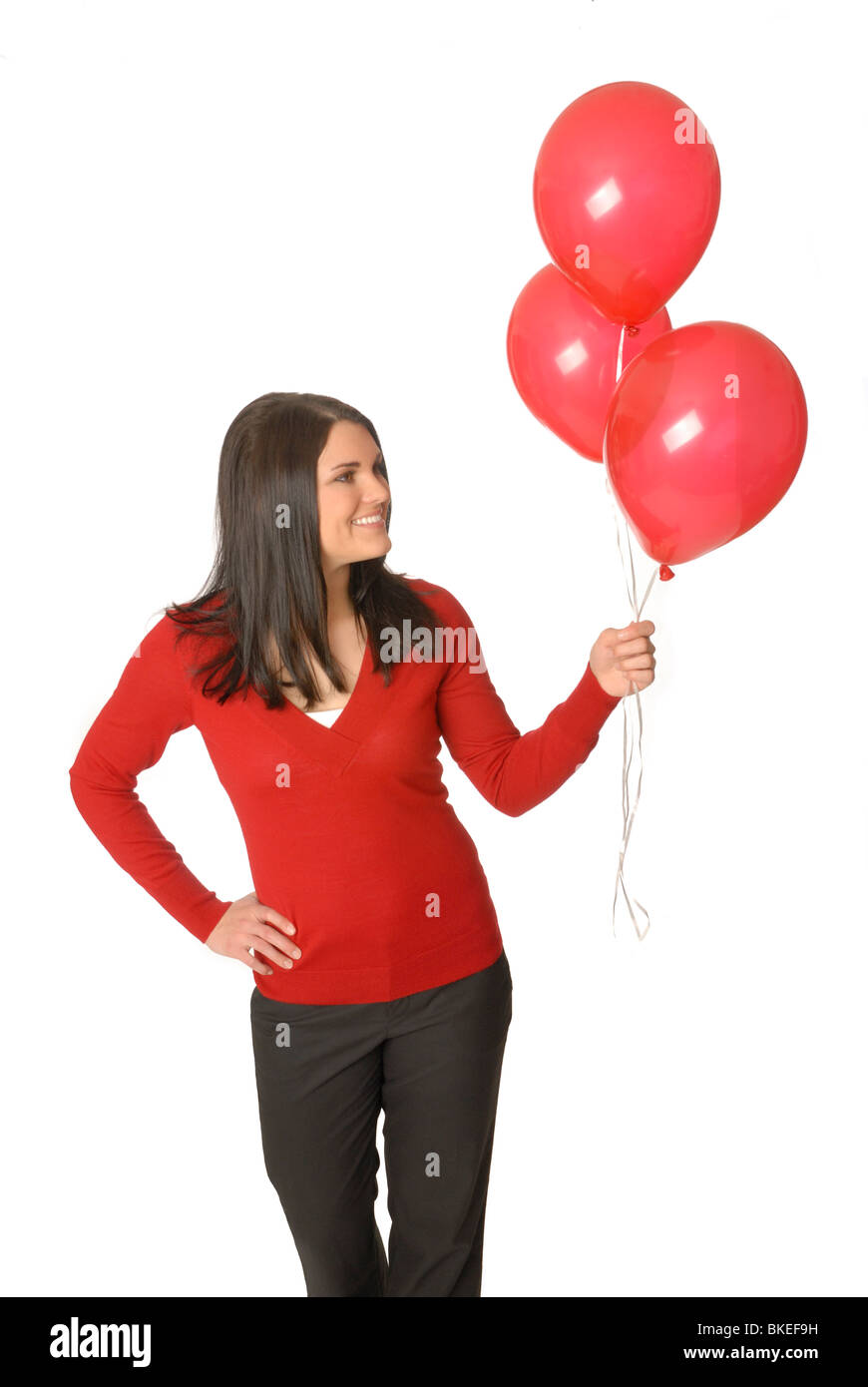Donna attraente con palloncini rossi. Foto Stock