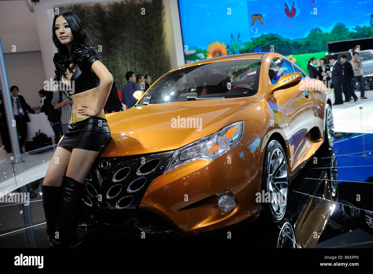 Un modello deside pone una Geely EMGRAND GT presso il Beijing Auto Show 2010. Foto Stock