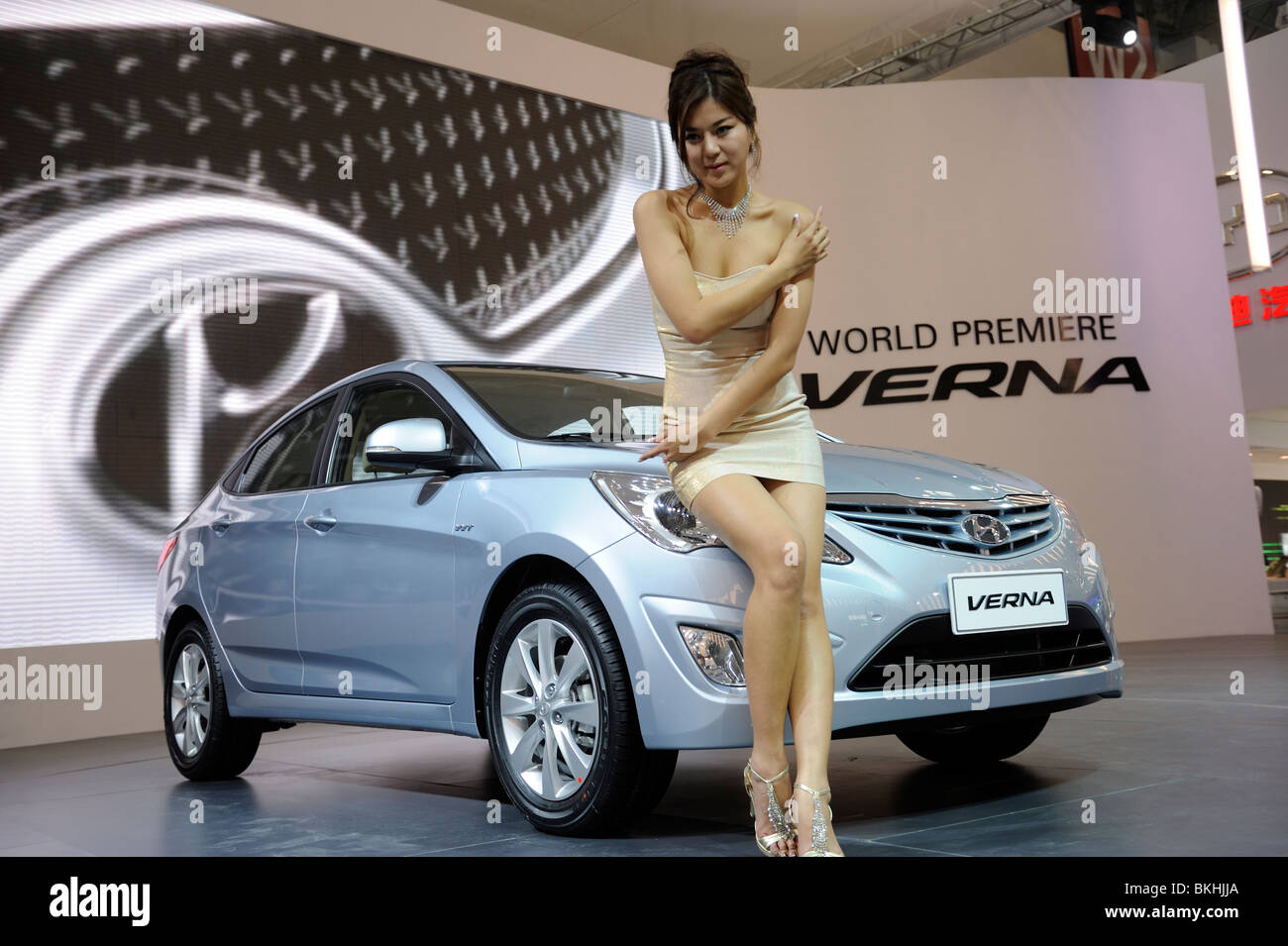 Un modello pone accanto a un Hyundai Verna a sua première mondiale a Pechino Auto Show. 24-Apr-2010 Foto Stock