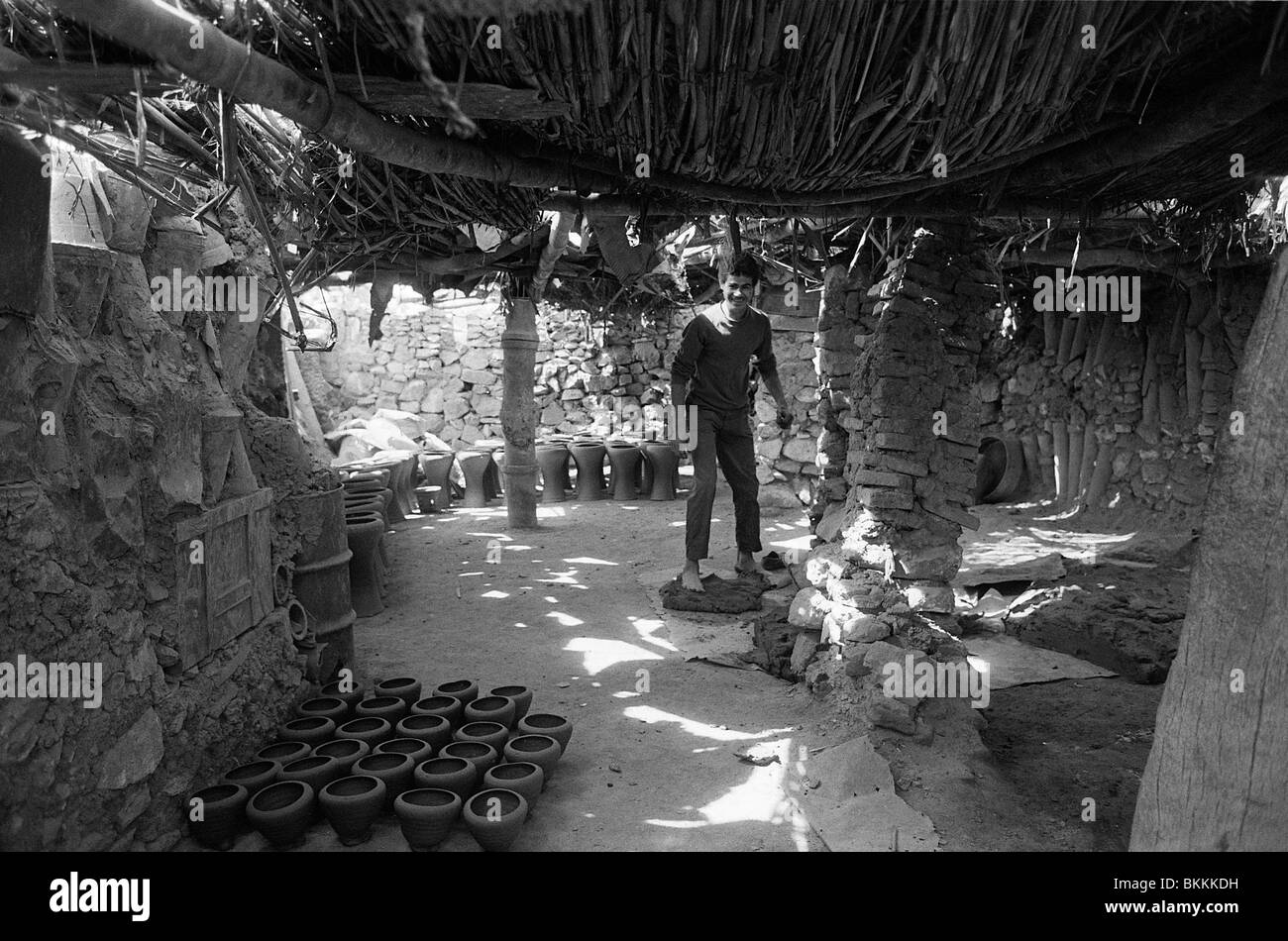 Un giovane uomo di argilla si prepara per il lancio in un laboratorio di ceramica nel distretto di Fustat del Cairo, Egitto Foto Stock