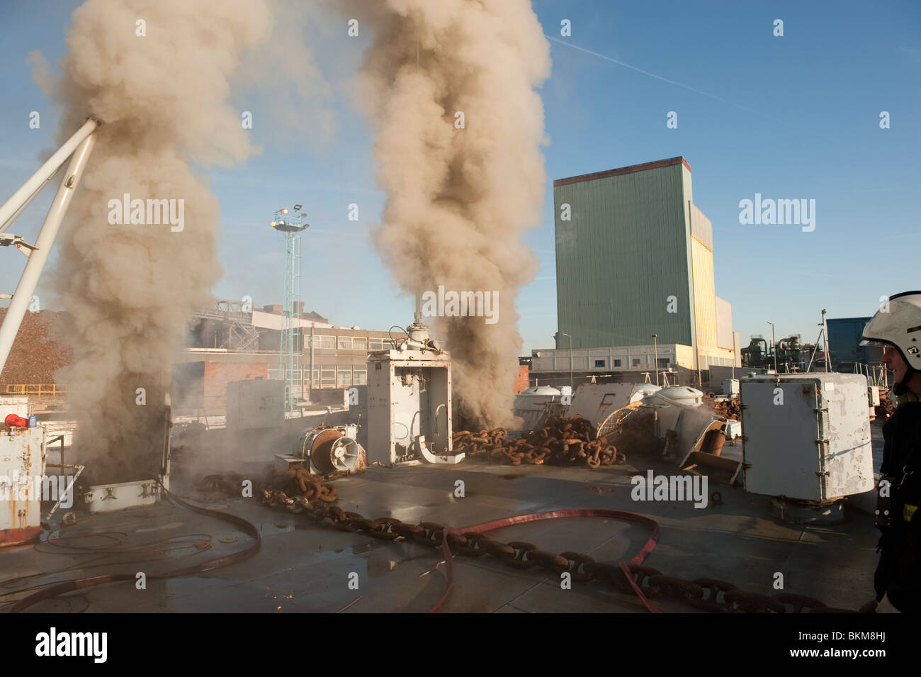 Ex nave della marina americana sul fuoco nel dock con grandi volumi di fumo proveniente dallo stato di attesa Foto Stock