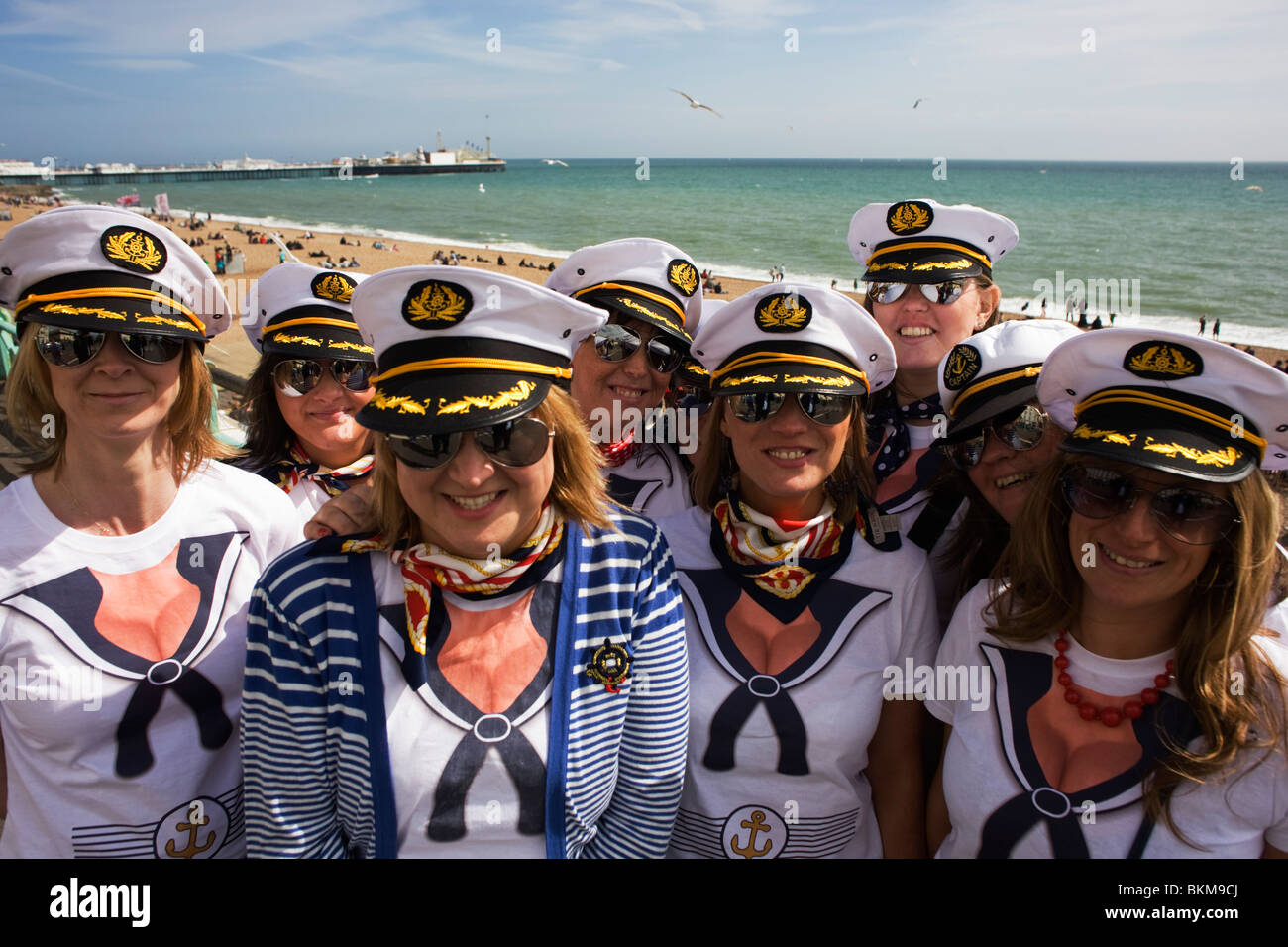 Hen party le donne indossano corrispondenti tappi nautici occhiali da sole e godere di Brighton il mare su May Bank Holiday. Foto Stock