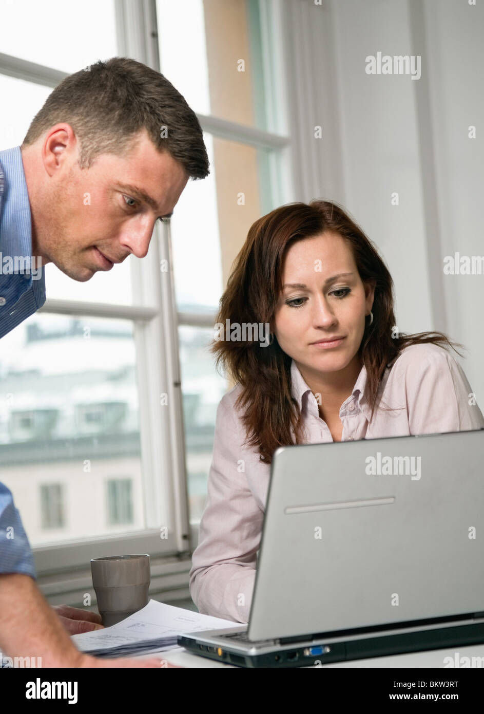Due colleghi guardando al laptop Foto Stock