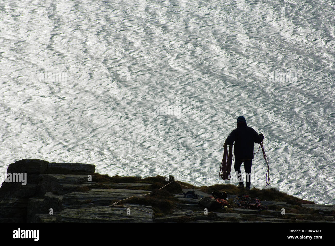 Scalatore di funi di preparazione al di sopra di scogliere a baratri, Isola di Man Foto Stock