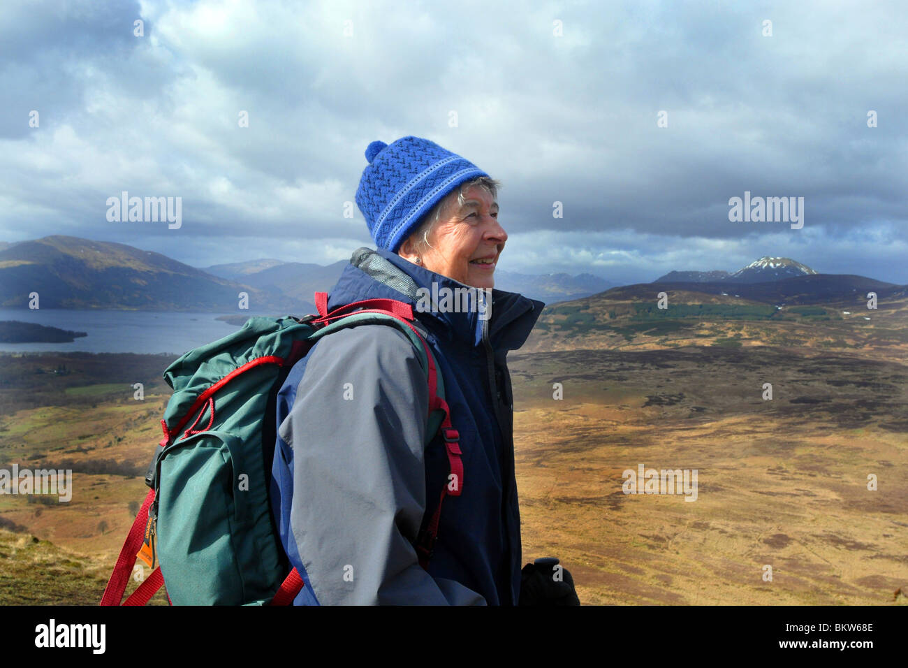 Persone anziane attive andare passeggiate in collina nel Trossachs National Park, Scozia Foto Stock