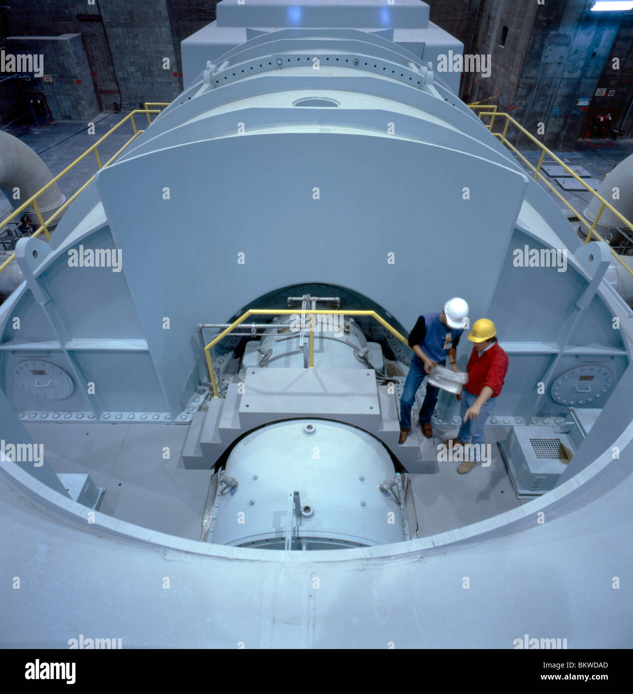 Due lavoratori disegno di revisione in prossimità di una turbina a vapore in corrispondenza di una centrale nucleare a Limerick, Pennsylvania, STATI UNITI D'AMERICA Foto Stock