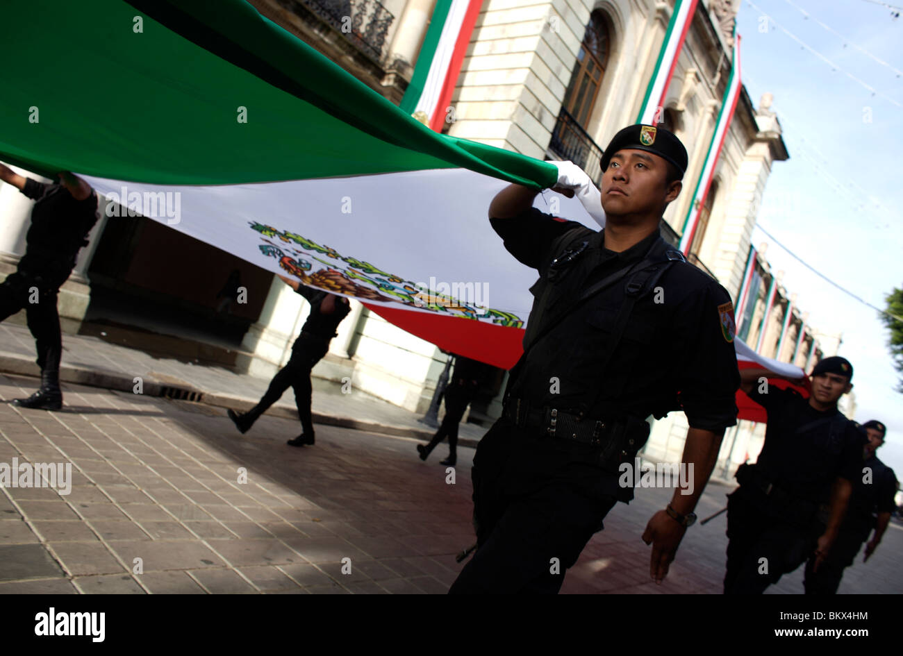 Poliziotti di trasportare il Messico di bandiera durante una cerimonia di inizio di indipendenza alle celebrazioni del giorno a Oaxaca, Messico Foto Stock