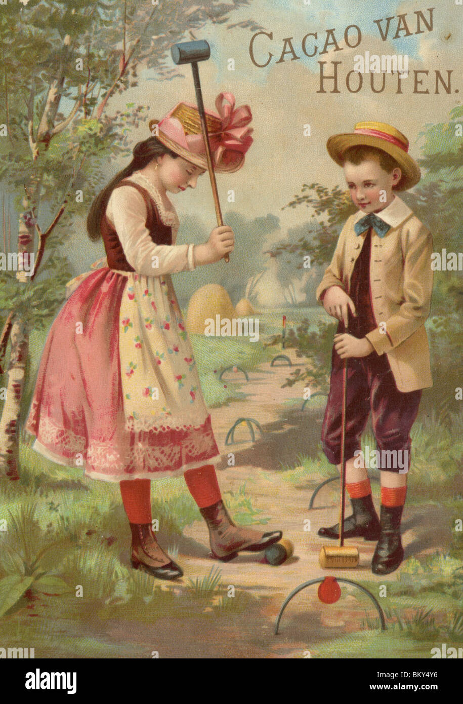 Due bambini di godersi una partita di croquet Foto Stock
