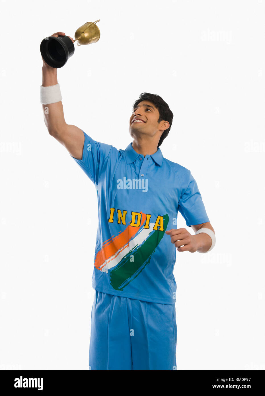 Giocatore di cricket che celebra il suo successo con un trofeo Foto Stock