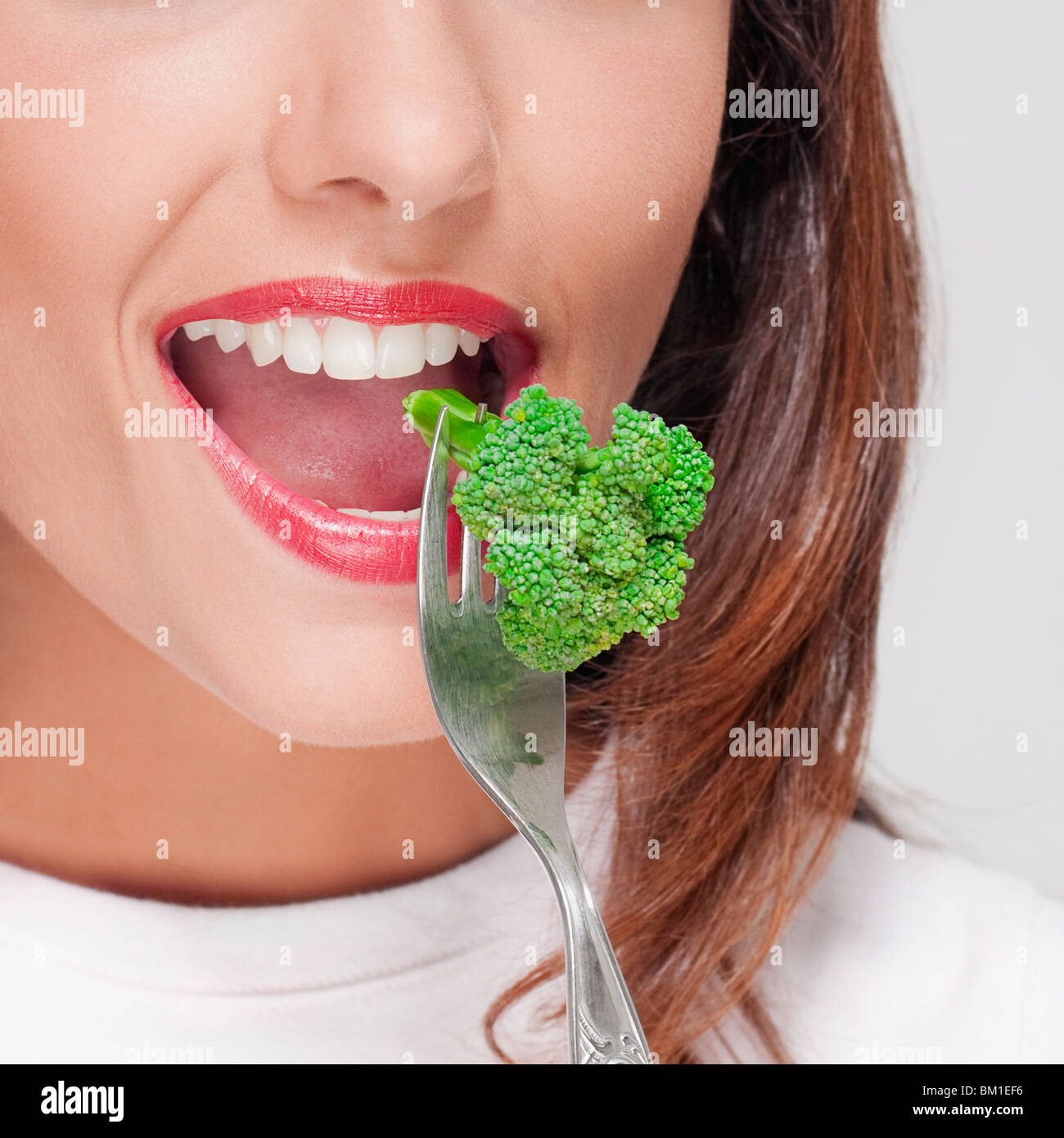 Close-up di una donna di mangiare i broccoli Foto Stock