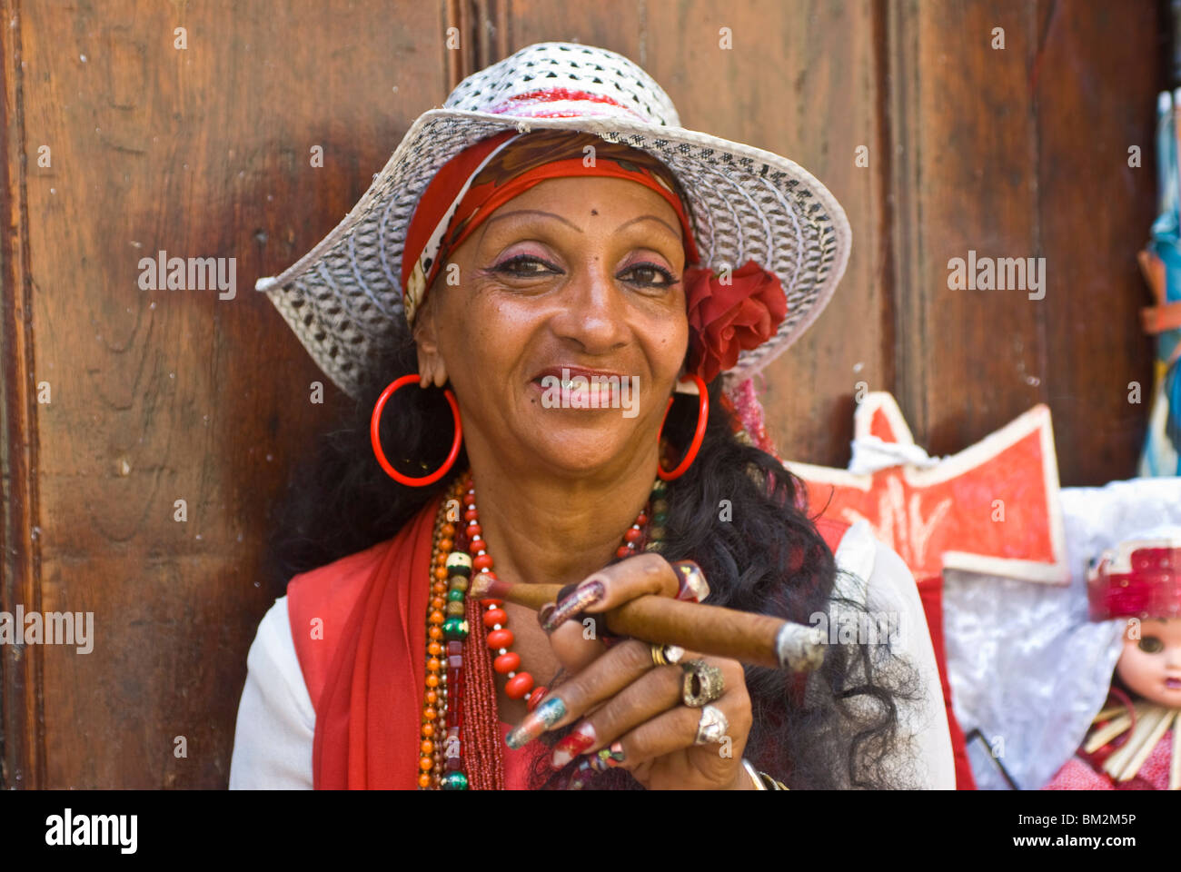 Tipico vestito donna cubana di fumare un sigaro gigante, Havana, Cuba, West Indies Foto Stock