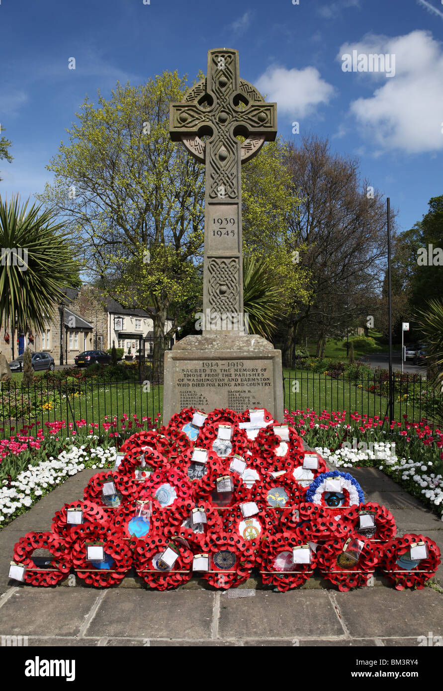 La decorazione floreale circonda il memoriale di guerra nel villaggio di Washington, Tyne and Wear, Inghilterra Foto Stock