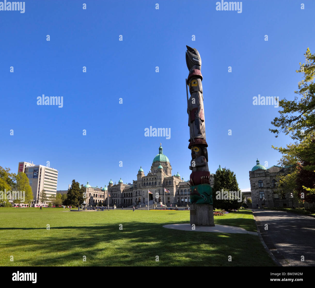 Il totem pole davanti a edifici del Parlamento, Victoria, British Columbia, Canada Foto Stock