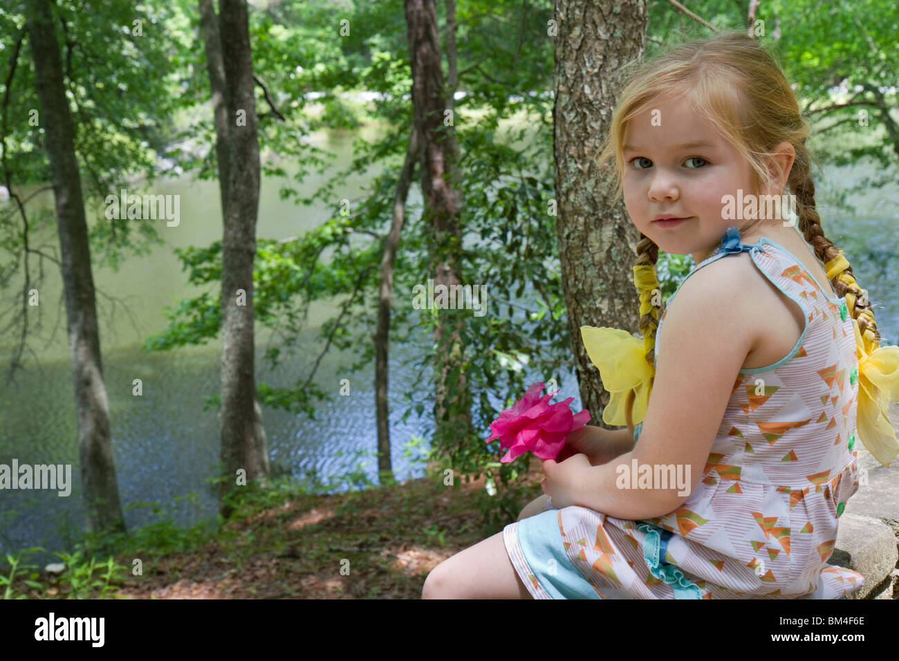 Una ragazza di 5 anni con un fiore: Divertimento all'aperto, Georgia, USA Foto Stock